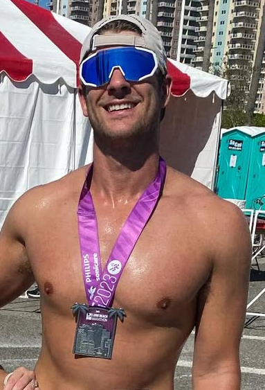 Michael B. wearing a race medal after a marathon