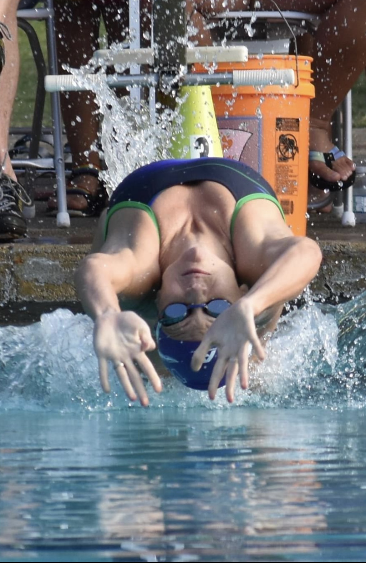 Swimmer exploding off the wall on a backstroke start
