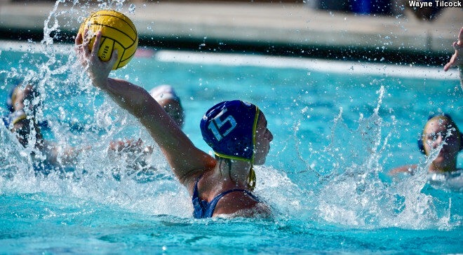 Water polo player rising out of the water to shoot